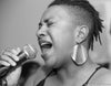 Woman Passionately Singing into a Microphone