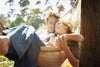 Man and Woman Smiling and Laying in a Hammock