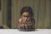 Young Girl Looking at a Chocolate Cake