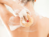 Woman Washing Her Back with Soap and Loofah