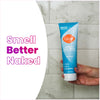 Hand holding a light blue Lume unscented acidified body wash inside a marble tile shower and text that says: Smell better naked