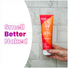 Hand holding a Lume clean tangerine scented acidified body wash inside a marble tile shower and text: Smell better naked