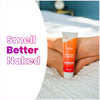 Lume clean tangerine cream deodorant tube on a white comforter next to a person's feet and the text: smell better naked