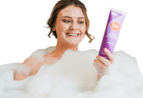 A woman in a bubbly bath holding Lume Acidified Body Wash.