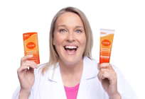 Dr. Shannon Klingman in a white lab coat, smiling with two Lume products