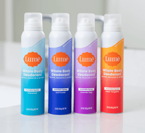 Lume spray deodorant products on bathroom countertop.