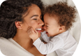 A woman and baby smiling at each other