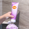 Open Lume lavender sage body wash tube dispensing on a loofah