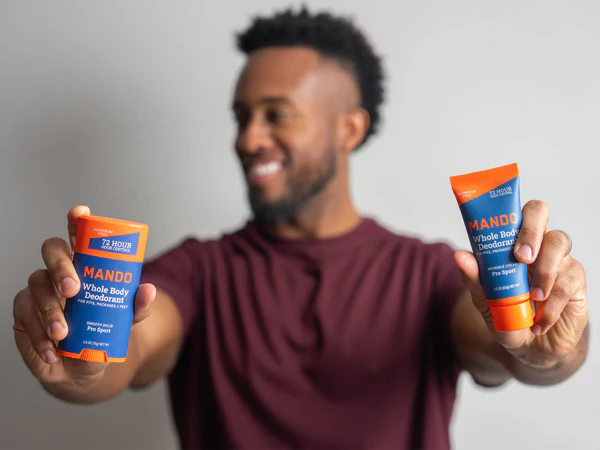 Man holding a Mando smooth stick and invisible cream tube