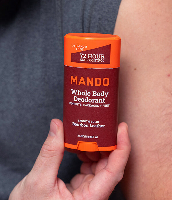 Person holding Mando Smooth Solid Stick deodorant in hand