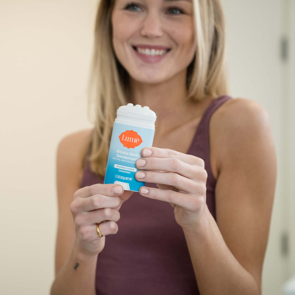 Blonde woman holding a unscented cream deodorant stick