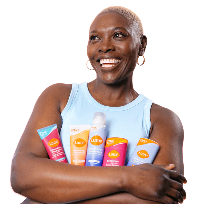 Woman holding various Lume products and smiling with arms crossed
